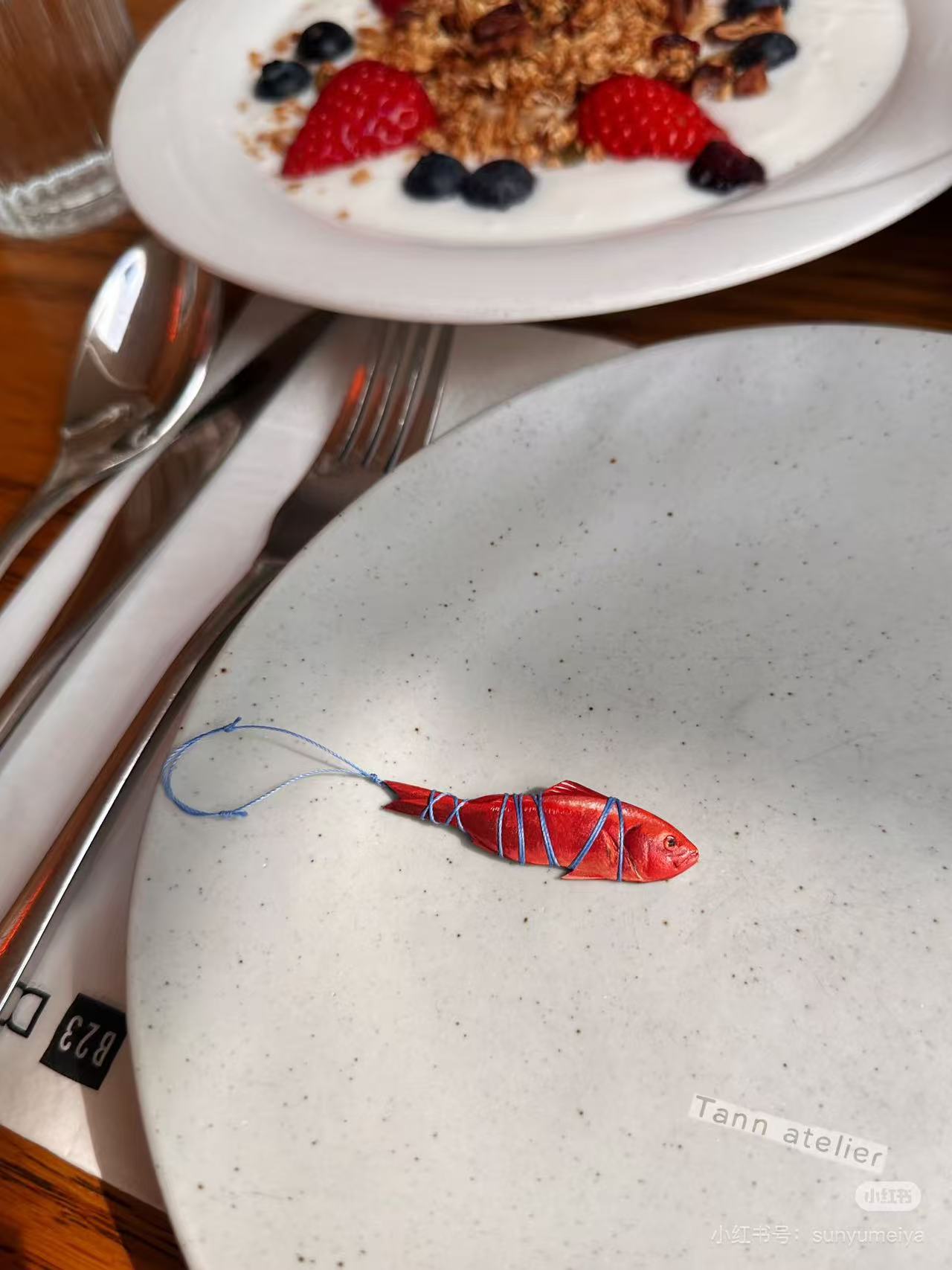 Red hand-carved leather fish charm